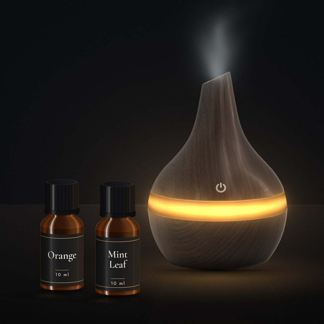 LUMUNO diffuser in Walnut with its two included 10ml essential oils, Orange and Mint Leaf